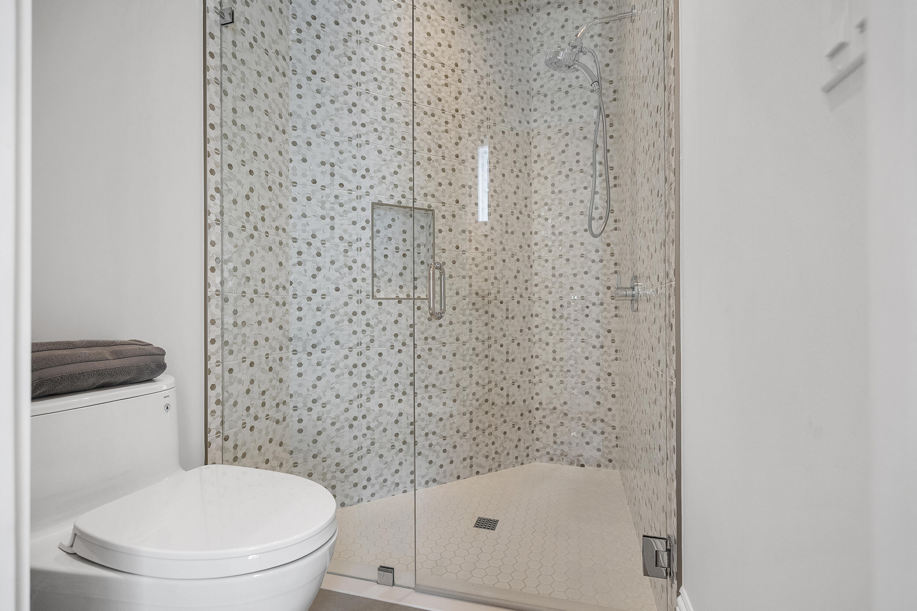 3973 Southeast Topsail Court Stuart, FL 34997 - Photo 19 of 38 a bathroom with a toilet and a shower