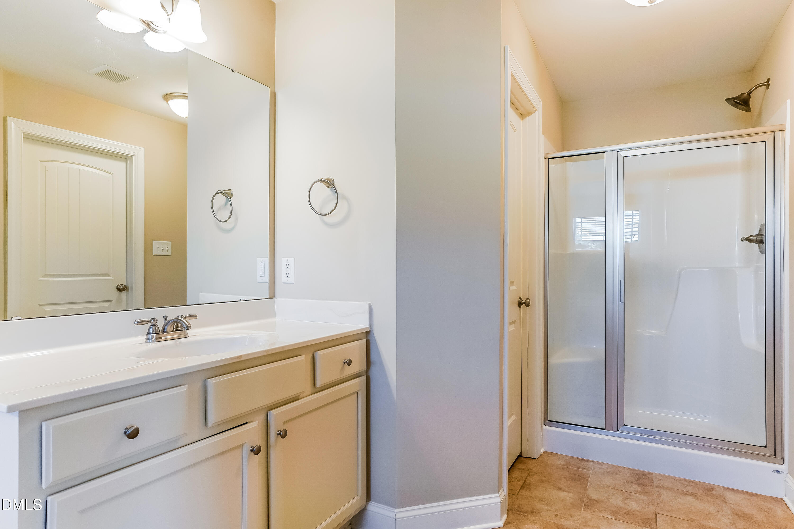 19 Labradoodle Court Garner, NC 27529 - Photo 11 of 17 a bathroom with a sink and a mirror