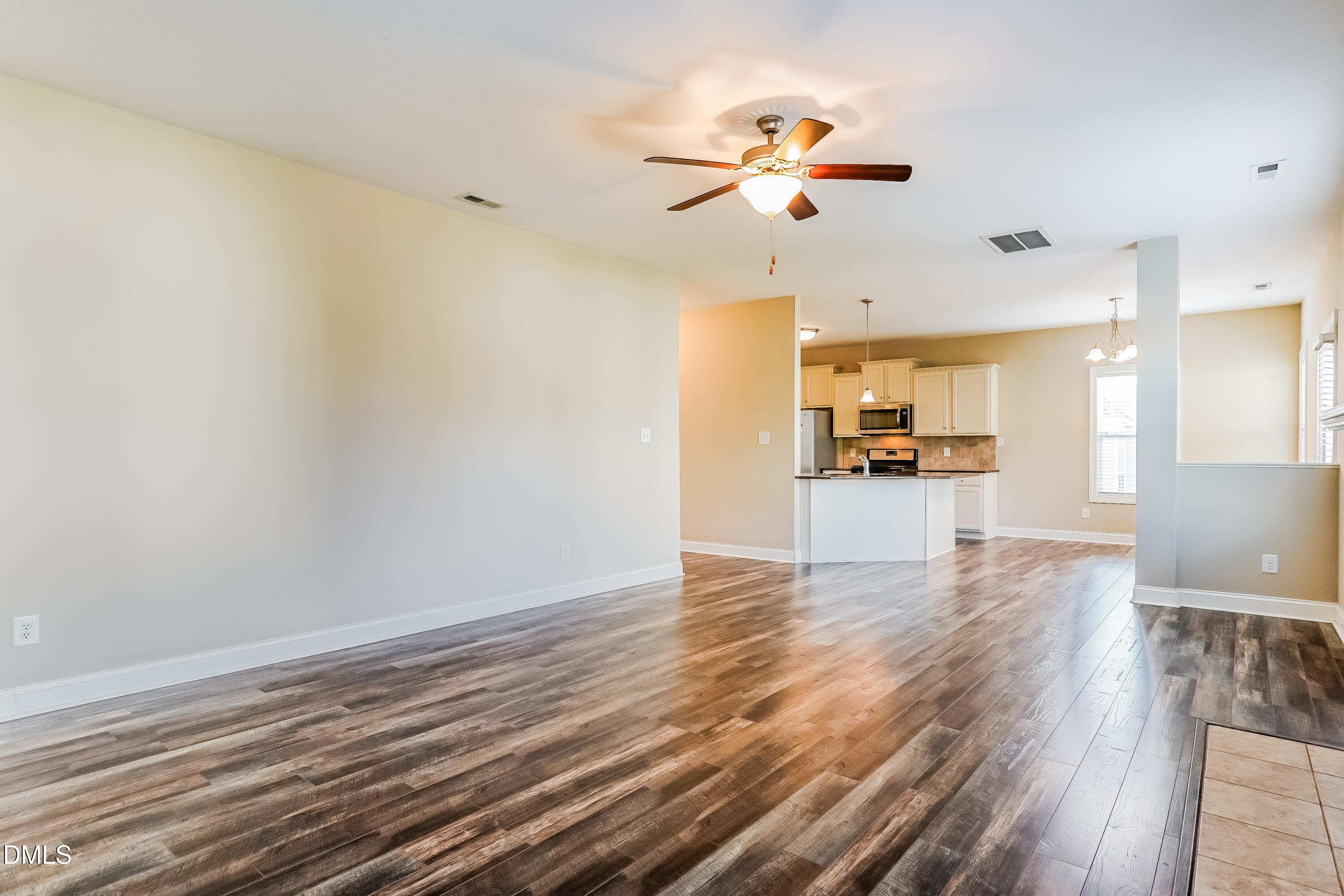 19 Labradoodle Court Garner, NC 27529 - Photo 2 of 17 a view of empty room with wooden floor and fan