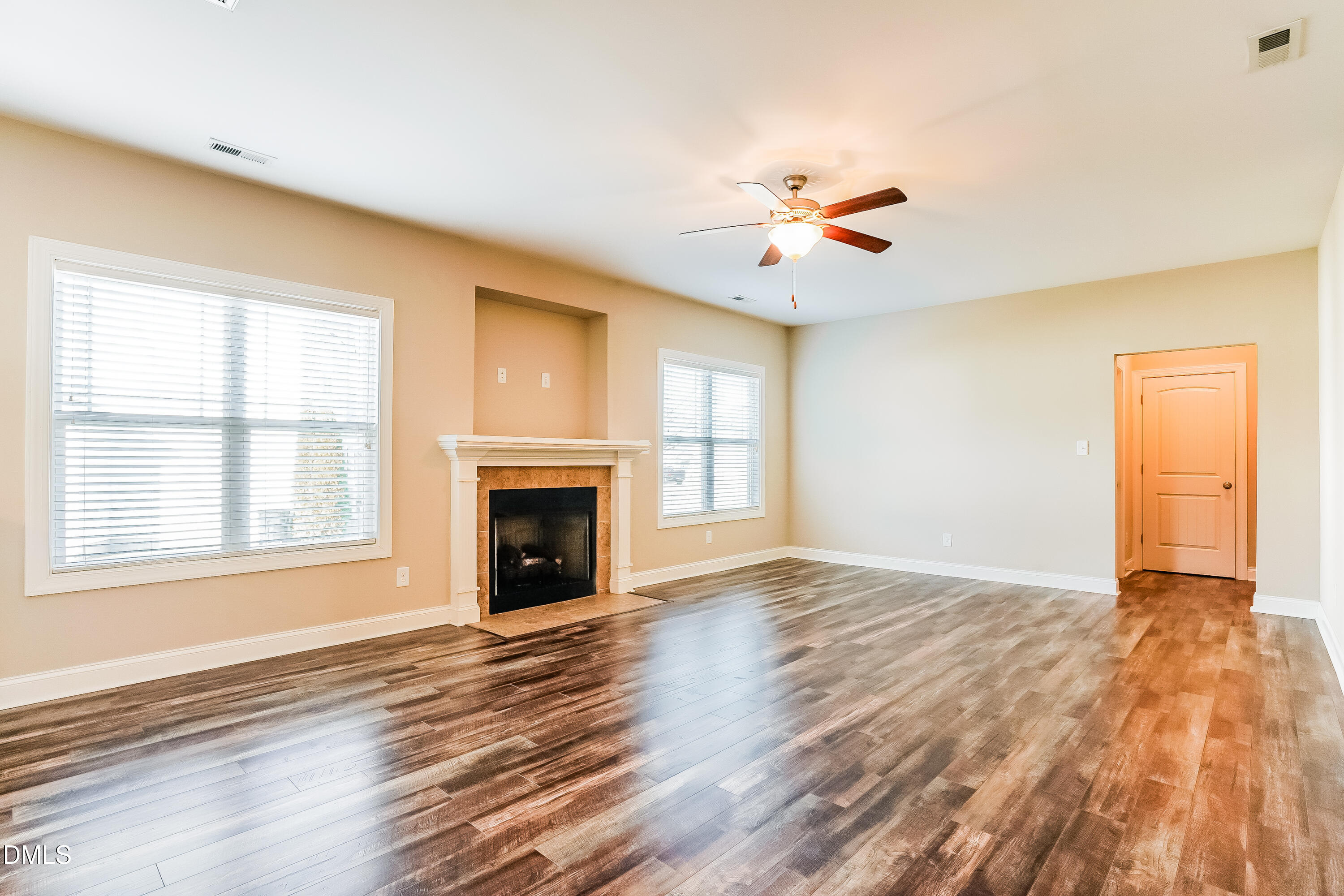 19 Labradoodle Court Garner, NC 27529 - Photo 3 of 17 an empty room with chandelier fan and wooden floor