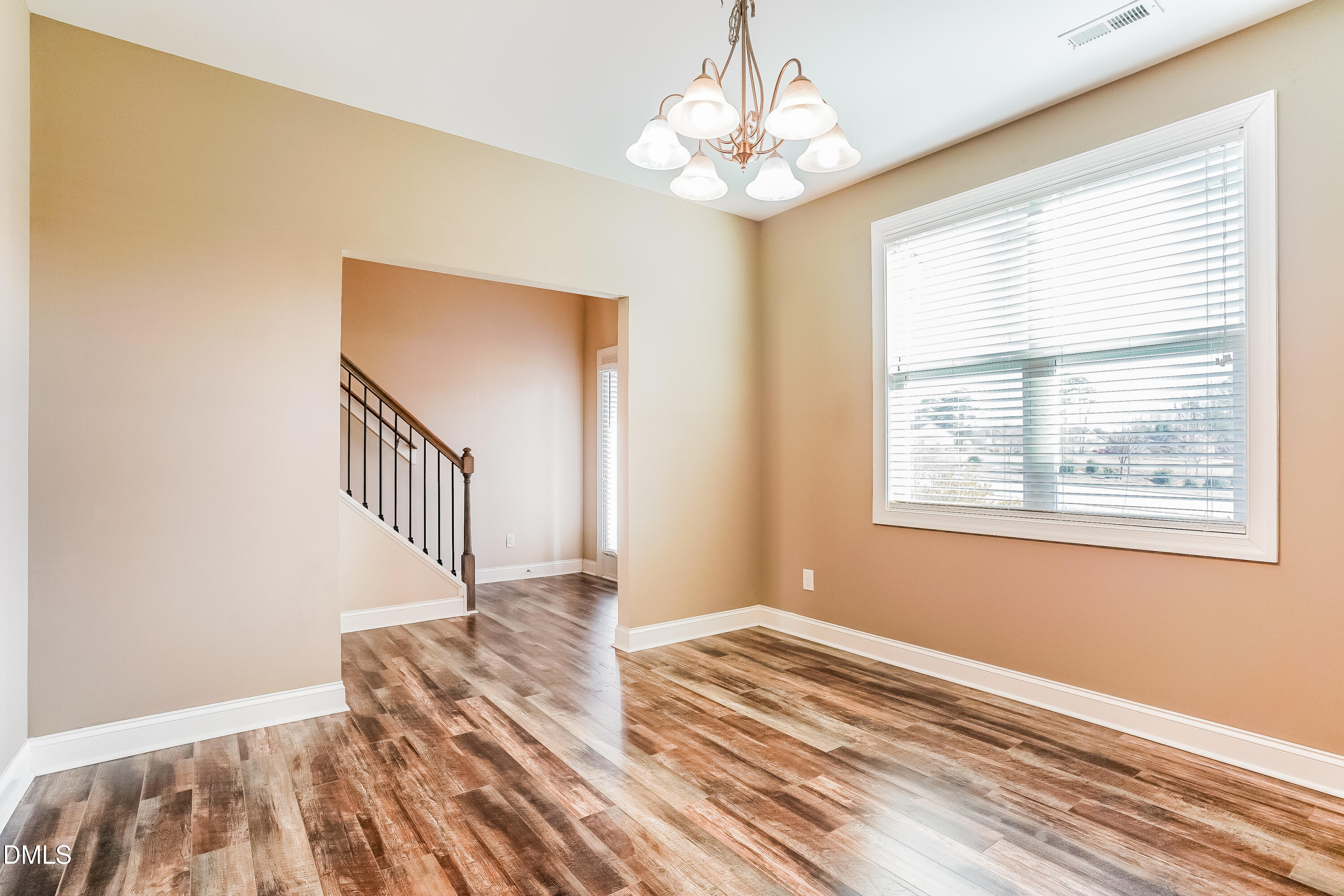 19 Labradoodle Court Garner, NC 27529 - Photo 4 of 17 a view of a livingroom with wooden floor and a chandelier