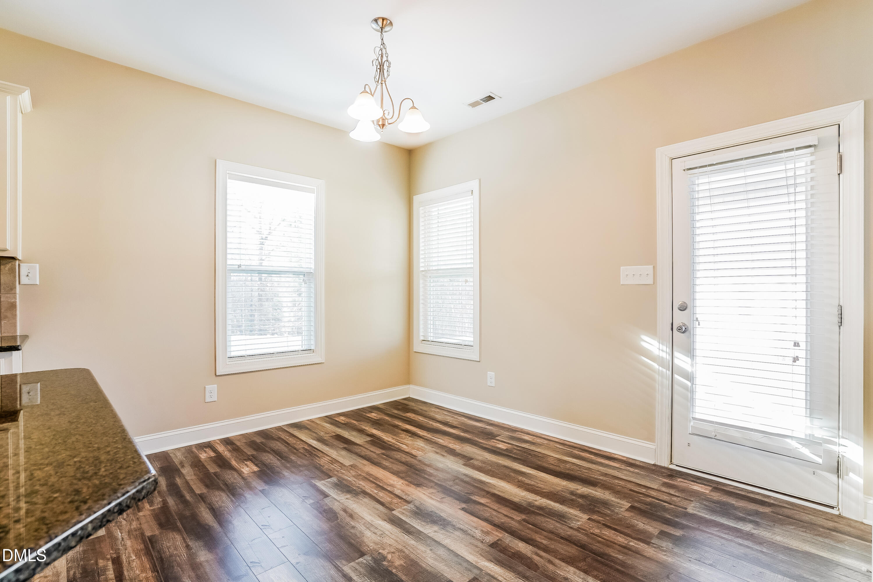 19 Labradoodle Court Garner, NC 27529 - Photo 5 of 17 a view of an empty room with wooden floor and a window