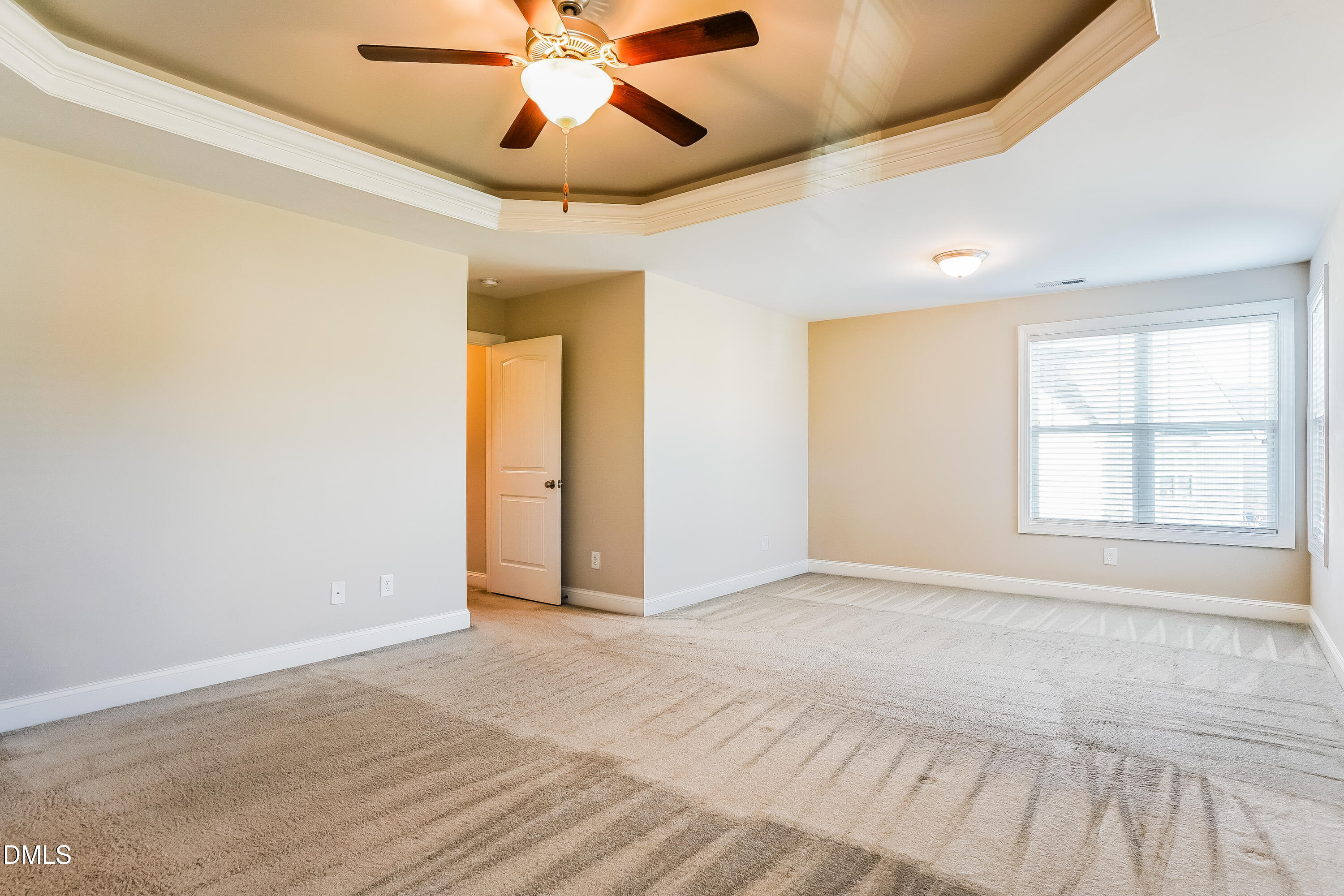 19 Labradoodle Court Garner, NC 27529 - Photo 8 of 17 an empty room with chandelier fan and windows