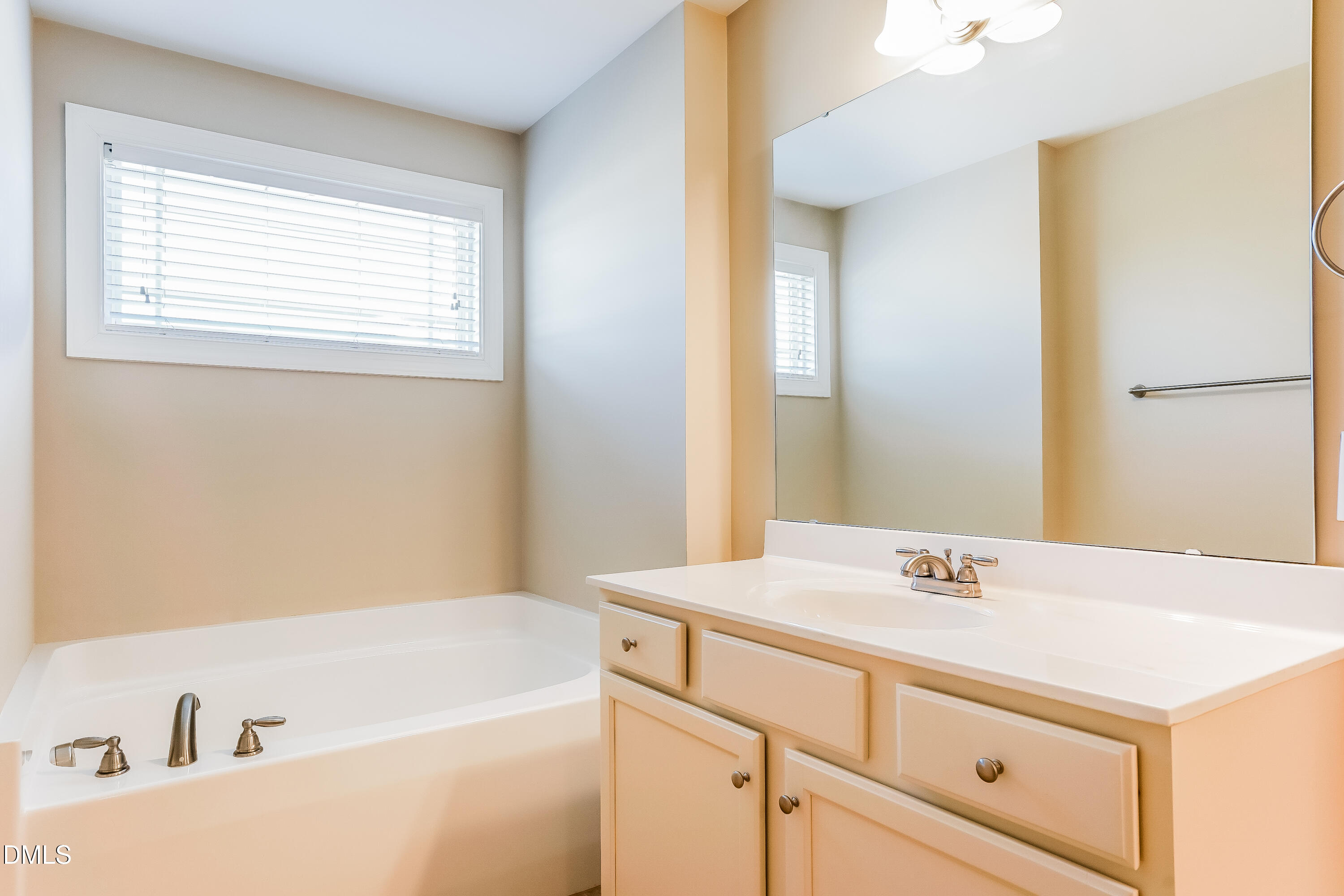 19 Labradoodle Court Garner, NC 27529 - Photo 10 of 17 a bathroom with a tub sink and mirror