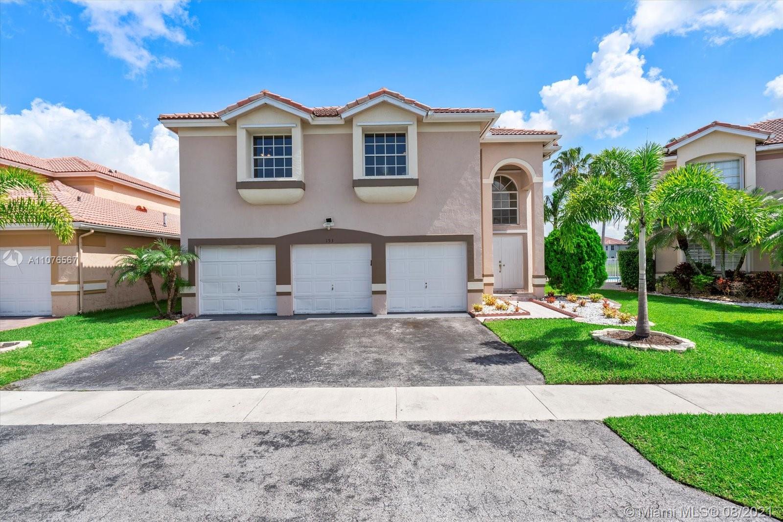 153 Granada Avenue Weston, FL 33326 - Photo 1 of 37 a front view of a house with garden