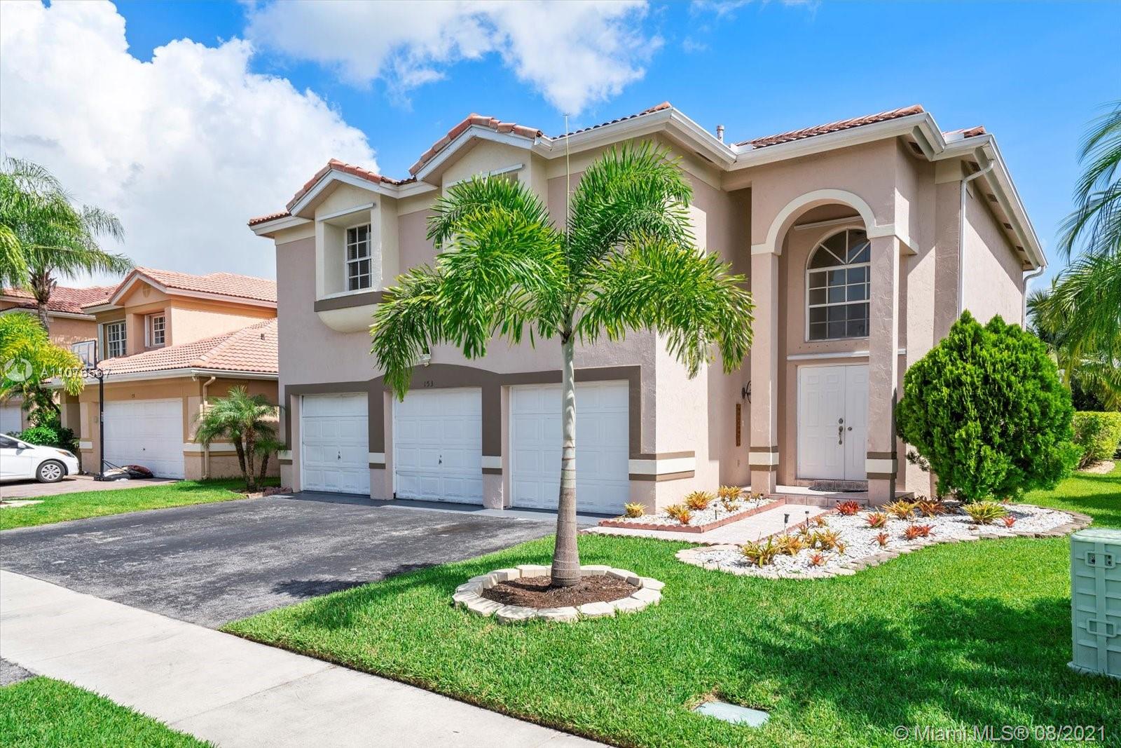 153 Granada Avenue Weston, FL 33326 - Photo 2 of 37 a front view of a house with a yard