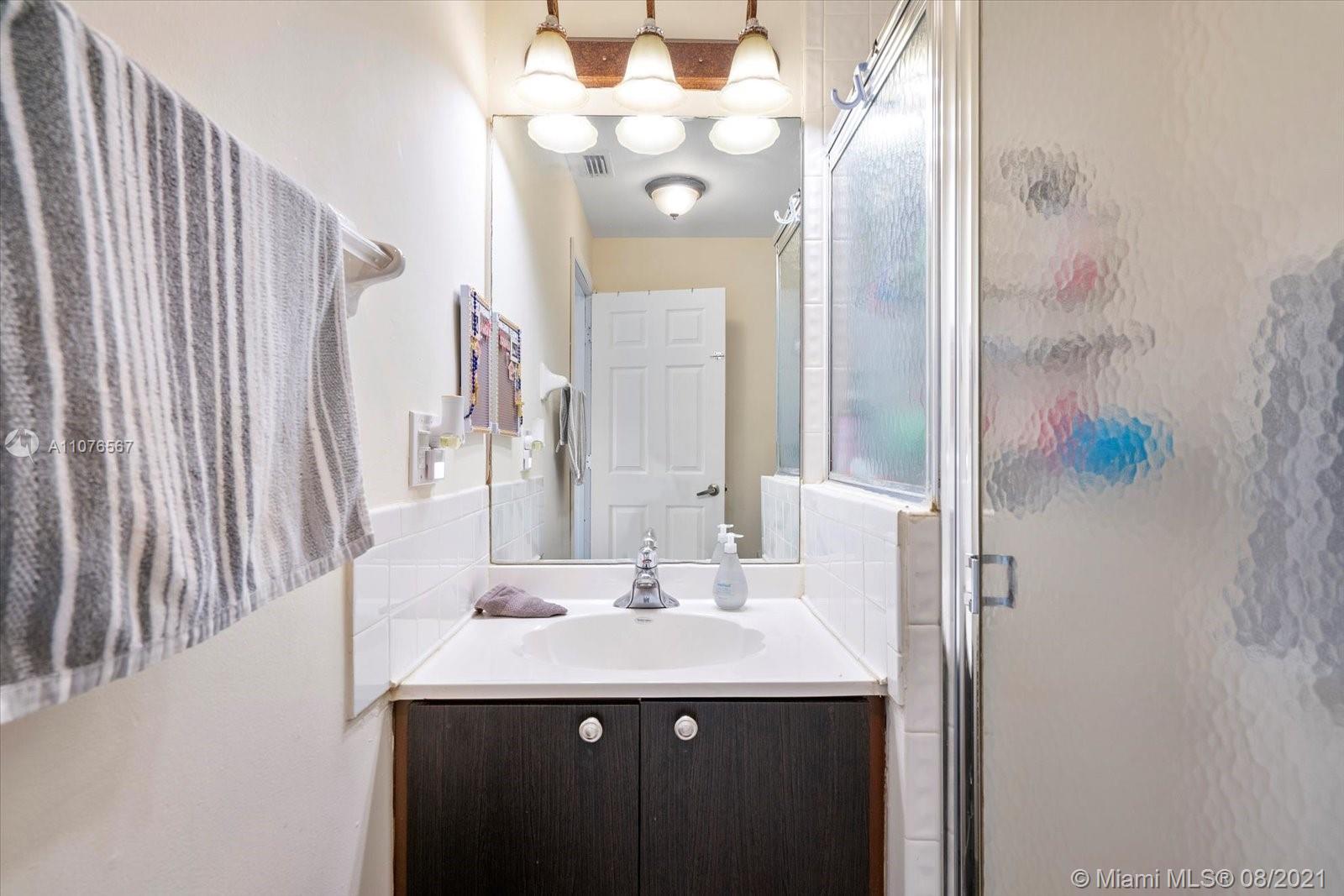 153 Granada Avenue Weston, FL 33326 - Photo 12 of 37 a bathroom with a sink and a mirror