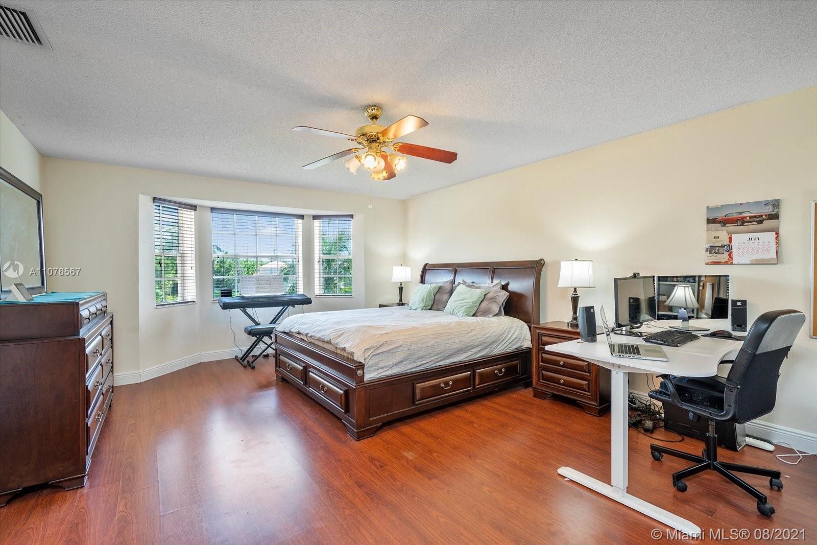 153 Granada Avenue Weston, FL 33326 - Photo 16 of 37 a bedroom with a bed and a desk