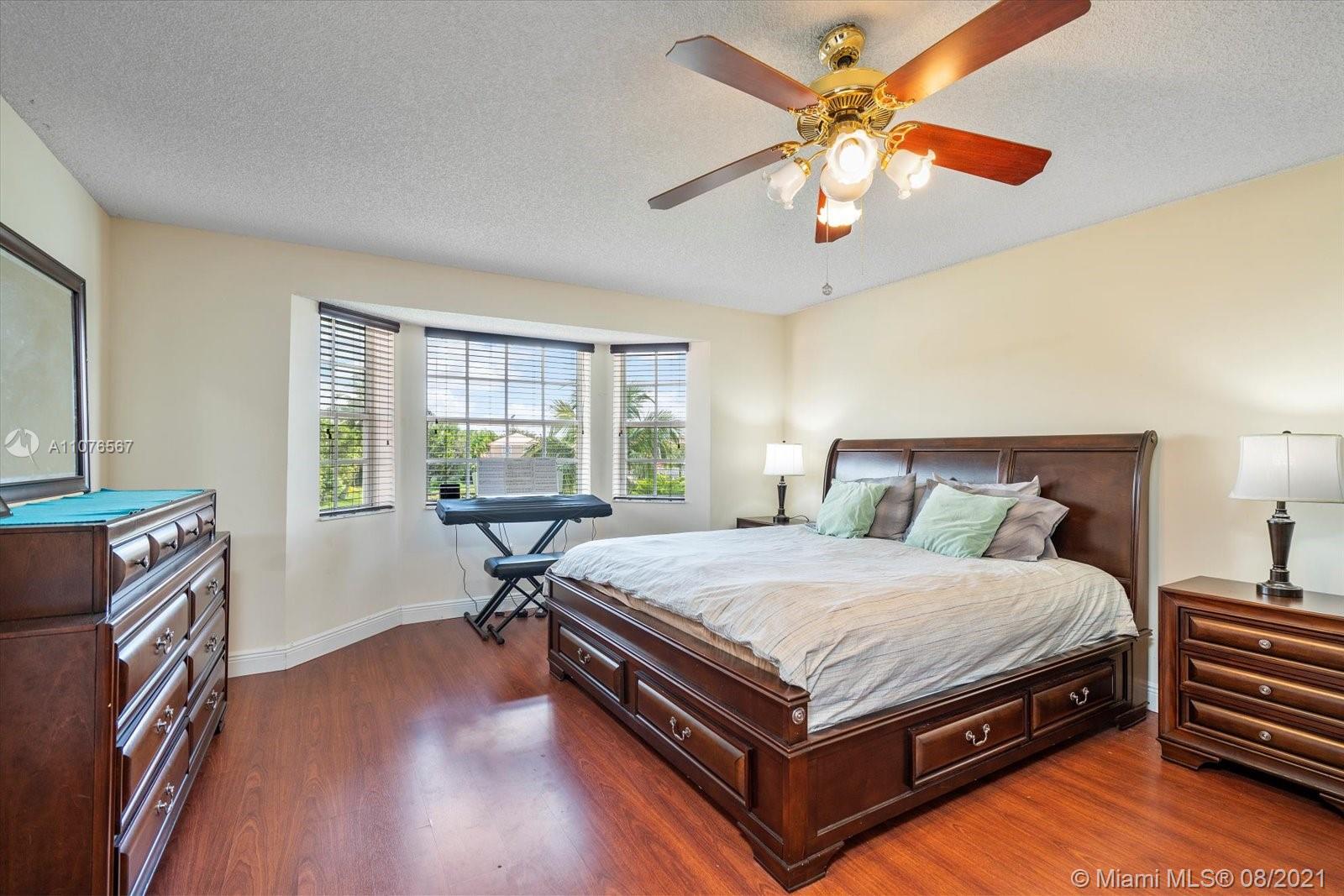153 Granada Avenue Weston, FL 33326 - Photo 17 of 37 a bedroom with a bed and window