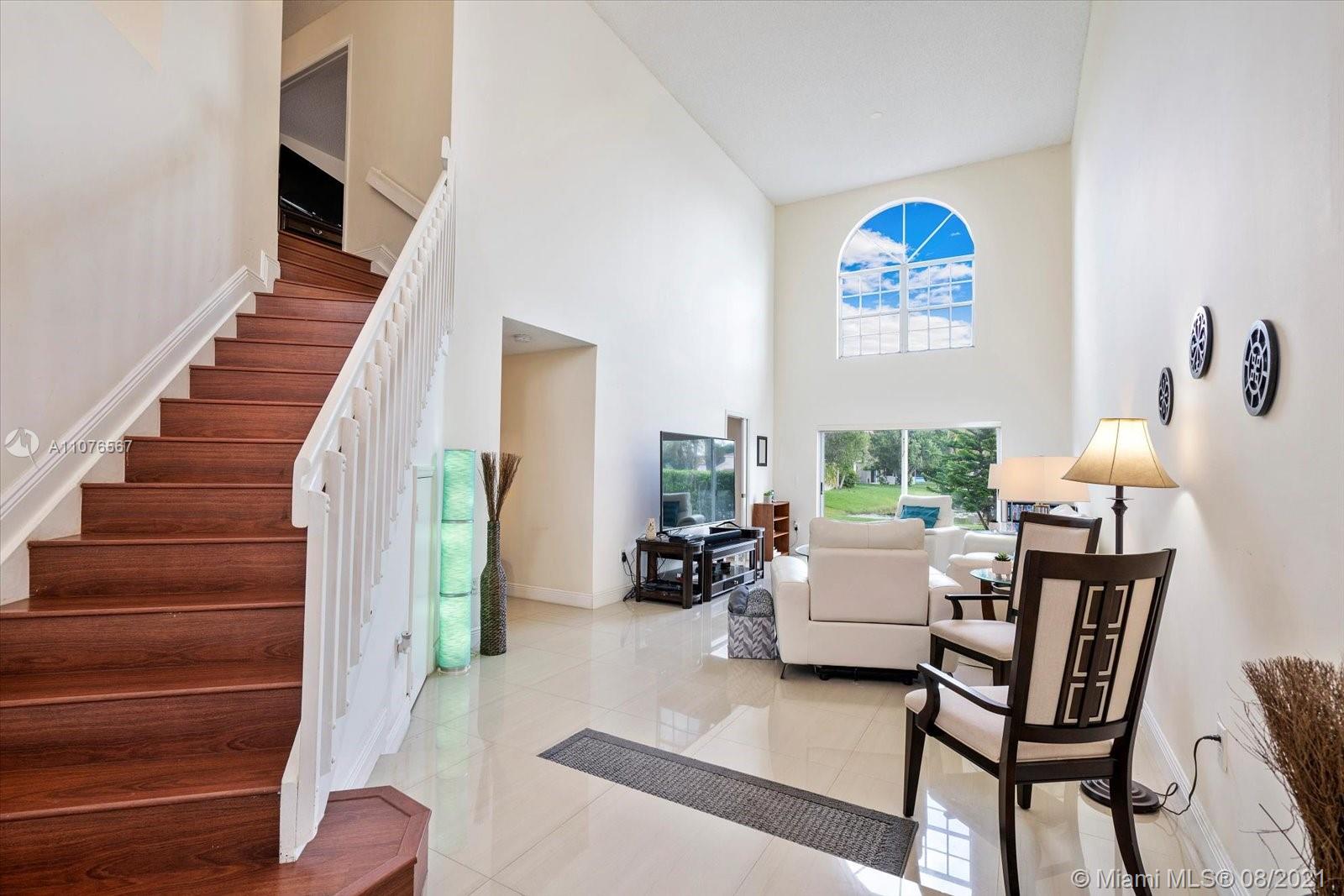 153 Granada Avenue Weston, FL 33326 - Photo 3 of 37 a living room with furniture and a gate
