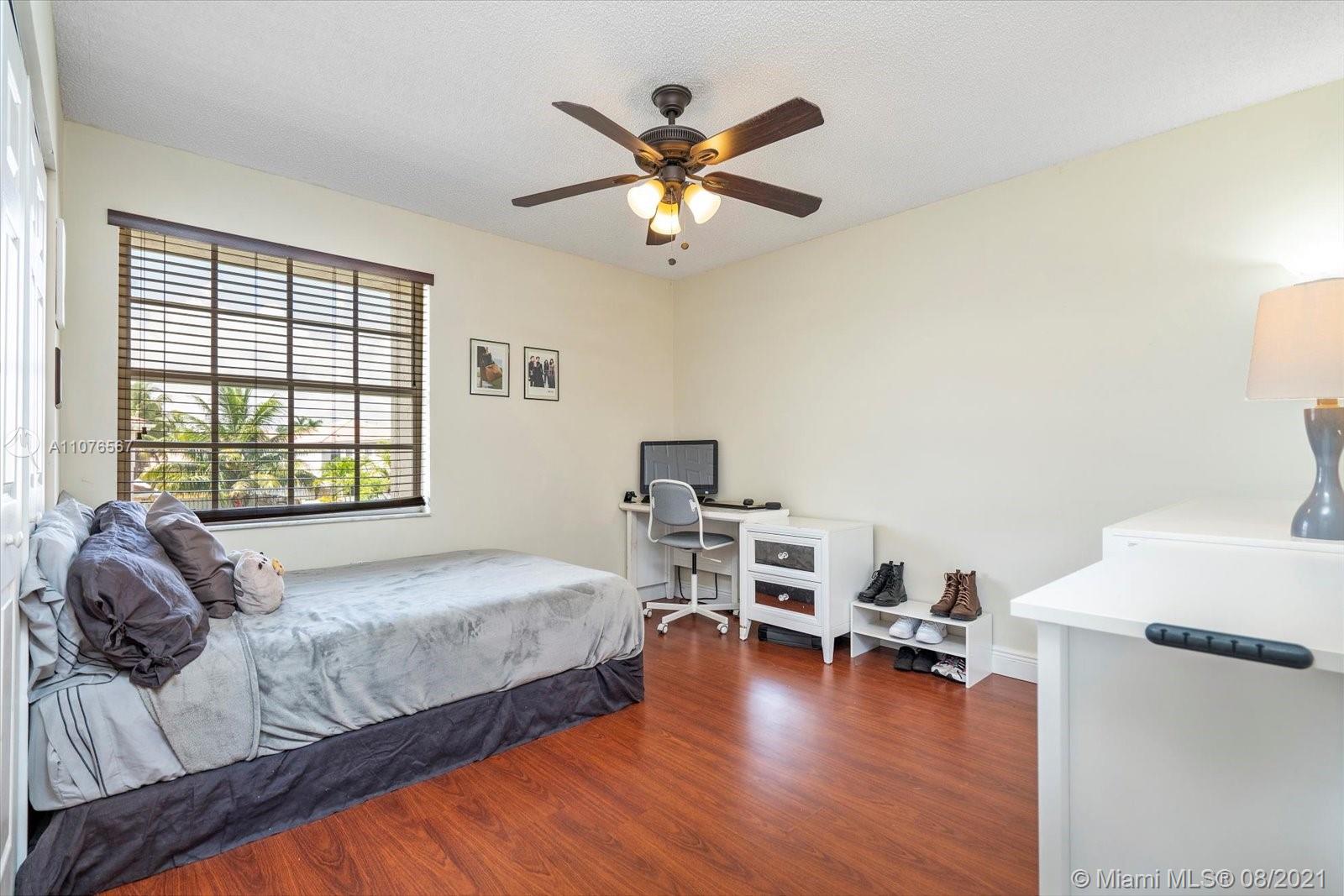 153 Granada Avenue Weston, FL 33326 - Photo 24 of 37 a bedroom with furniture and a wooden floor