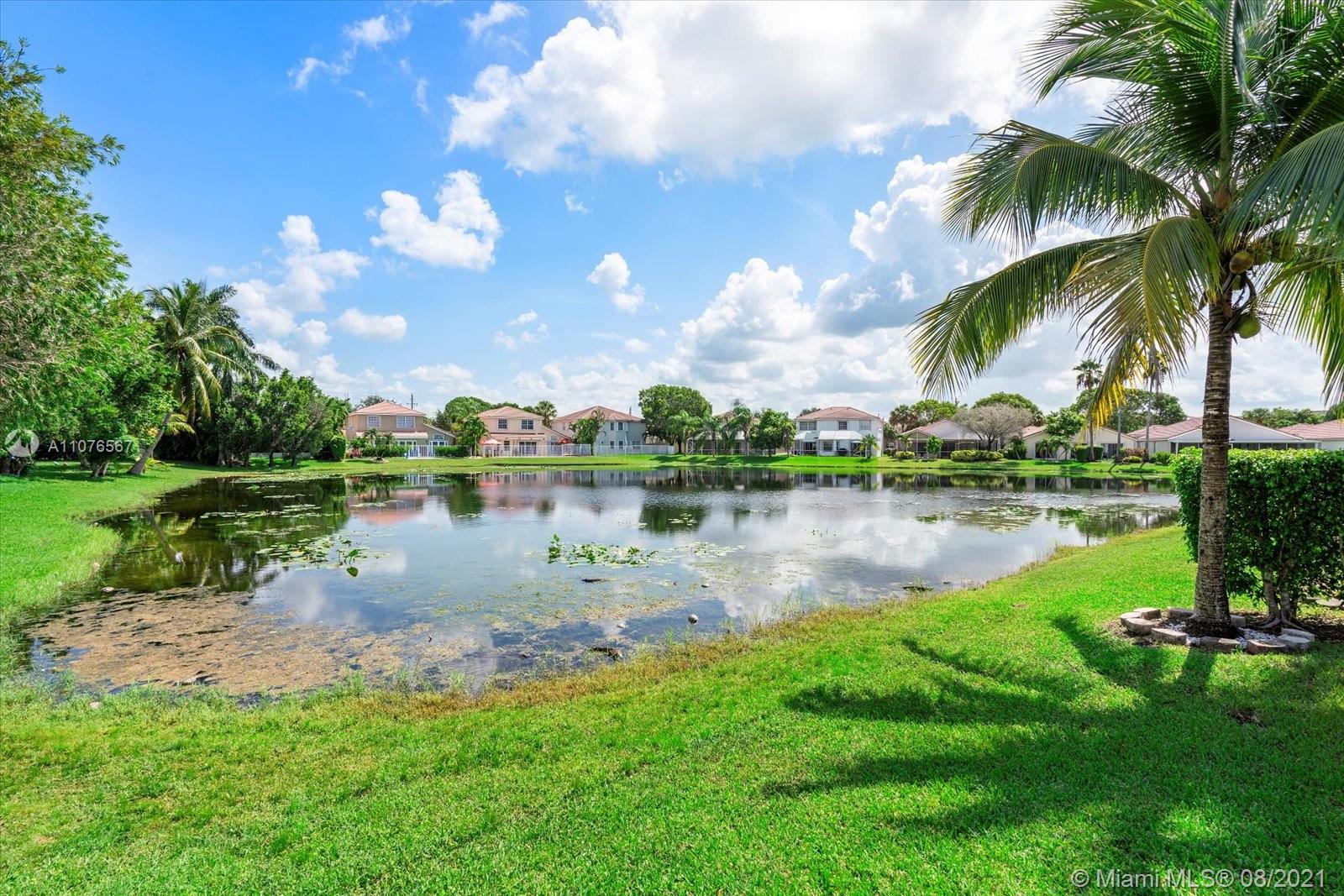 153 Granada Avenue Weston, FL 33326 - Photo 27 of 37 a lake view with a garden