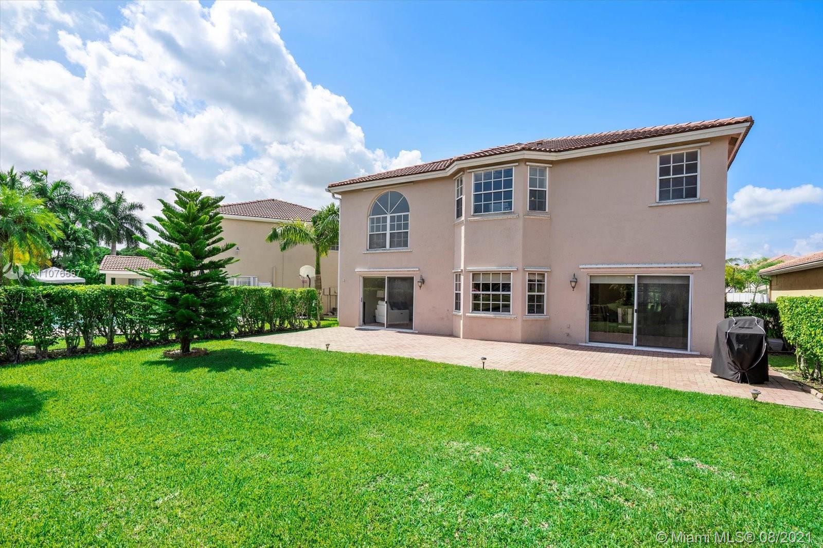 153 Granada Avenue Weston, FL 33326 - Photo 28 of 37 a front view of house with yard and green space