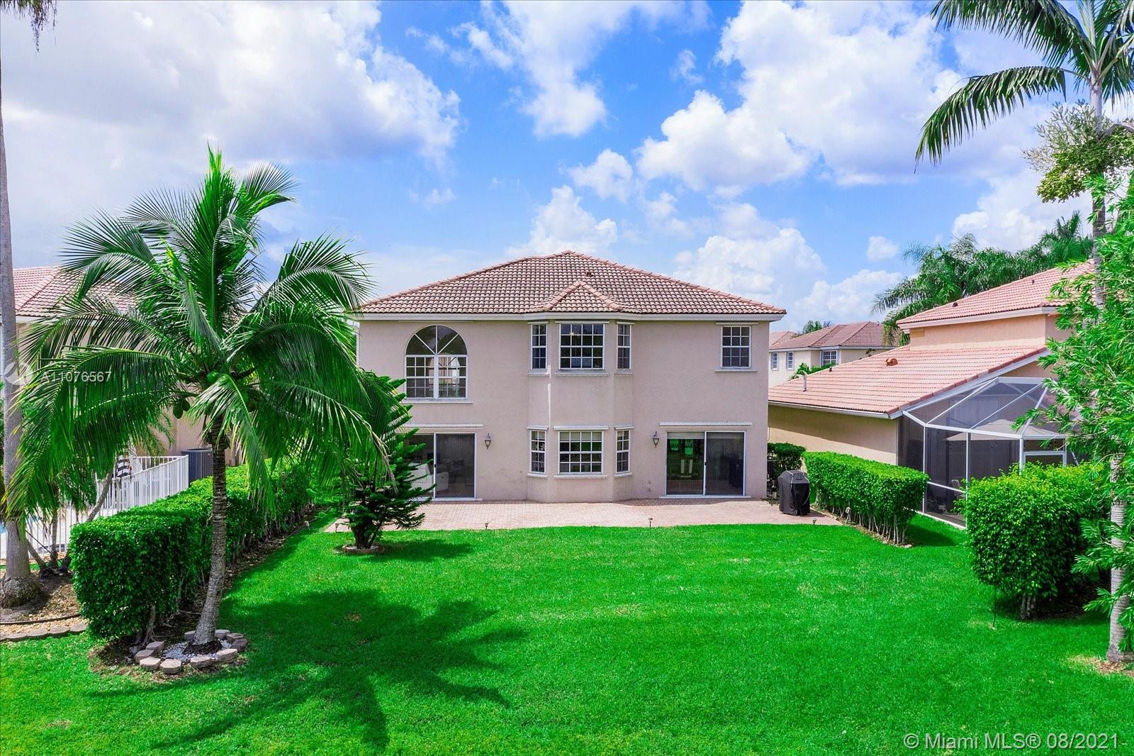 153 Granada Avenue Weston, FL 33326 - Photo 29 of 37 a front view of a house with yard and green space