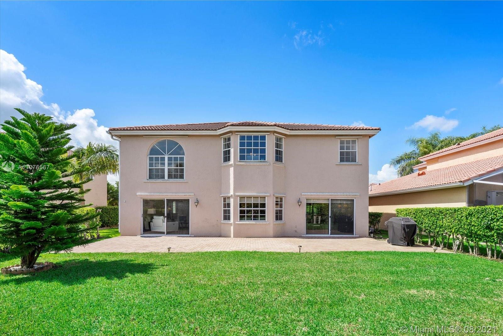153 Granada Avenue Weston, FL 33326 - Photo 30 of 37 a front view of a house with a garden