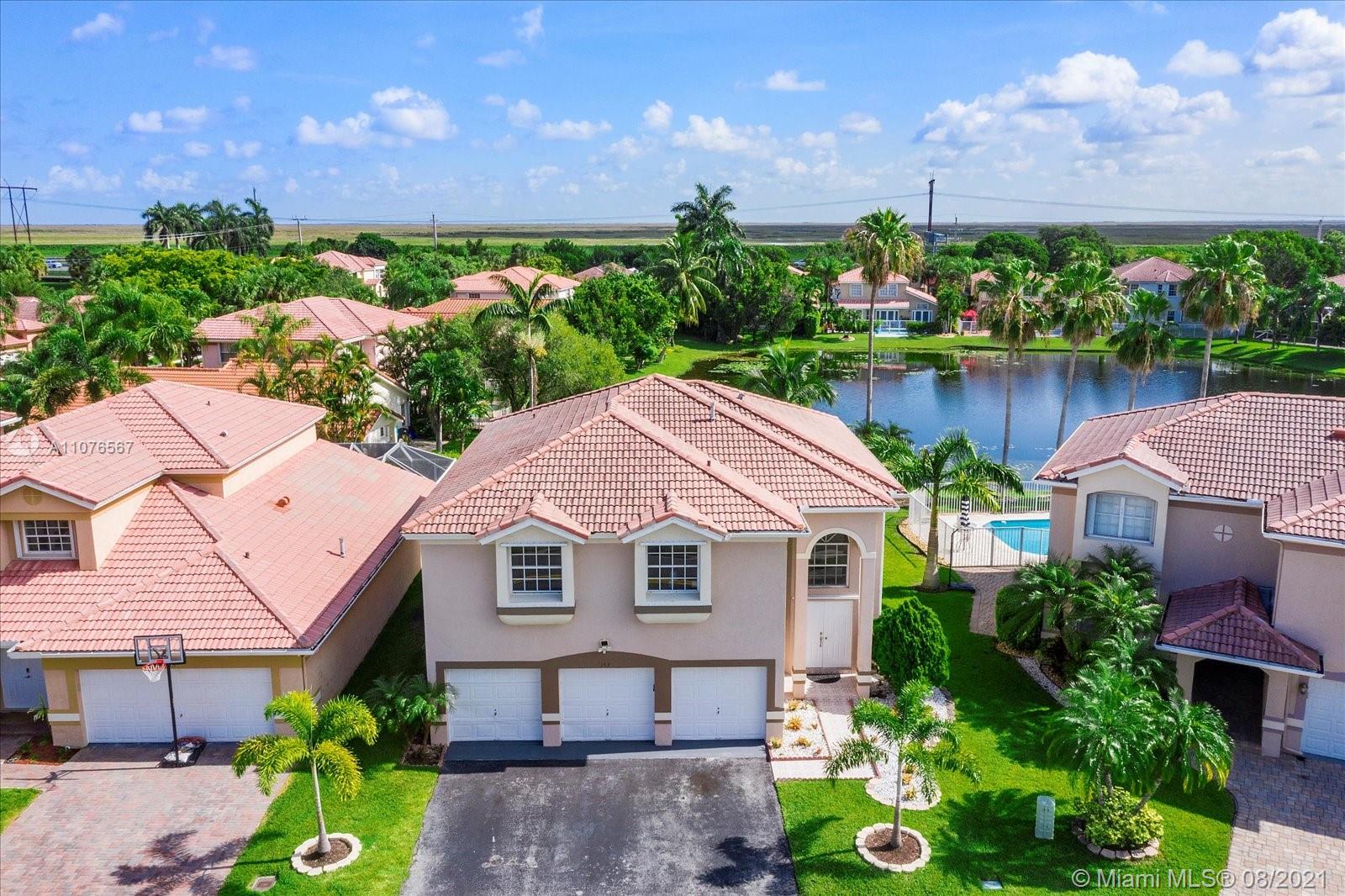 153 Granada Avenue Weston, FL 33326 - Photo 33 of 37 a aerial view of a house with a yard and a garden