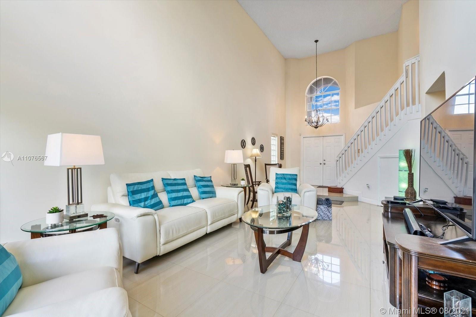 153 Granada Avenue Weston, FL 33326 - Photo 6 of 37 a living room with furniture and a table