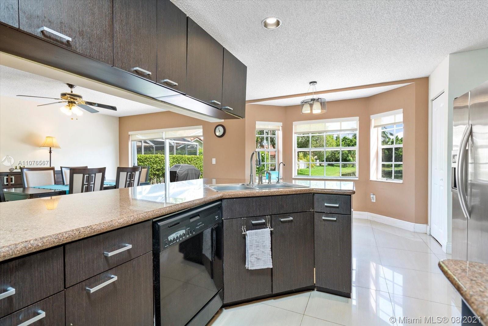 153 Granada Avenue Weston, FL 33326 - Photo 7 of 37 a kitchen with a sink and large window