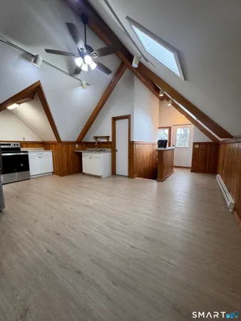 a view of an empty room with a chandelier