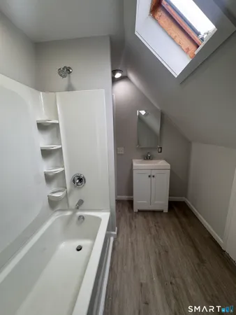 a bathroom with a sink a mirror and a bathtub