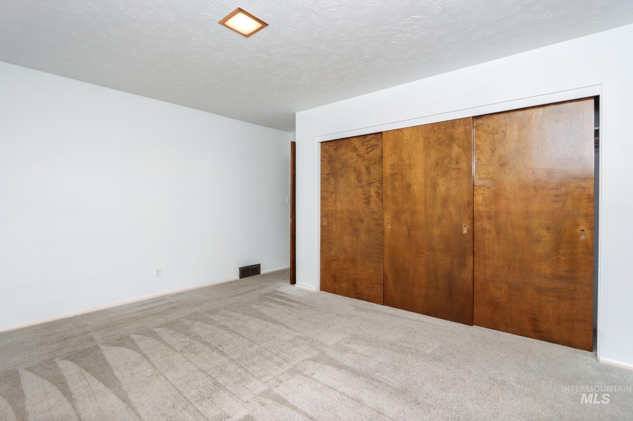 801 Thompson Avenue Nyssa, OR 97913 - Photo 16 of 46 Room featuring light-toned carpeting, white painted walls, and a recessed ceiling light