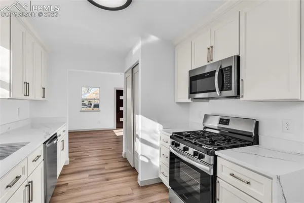 a kitchen with stainless steel appliances a refrigerator sink and cabinets