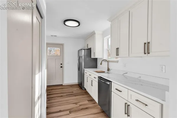a kitchen with stainless steel appliances a white stove top oven and cabinets