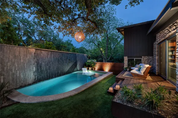 a view of a backyard with table and chairs potted plants and wooden fence