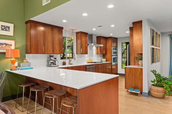 a large kitchen with a table and chairs