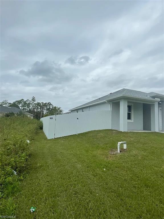 742 Eisenhower Boulevard Lehigh Acres, FL 33974 - Photo 11 of 11 a house view with a outdoor space