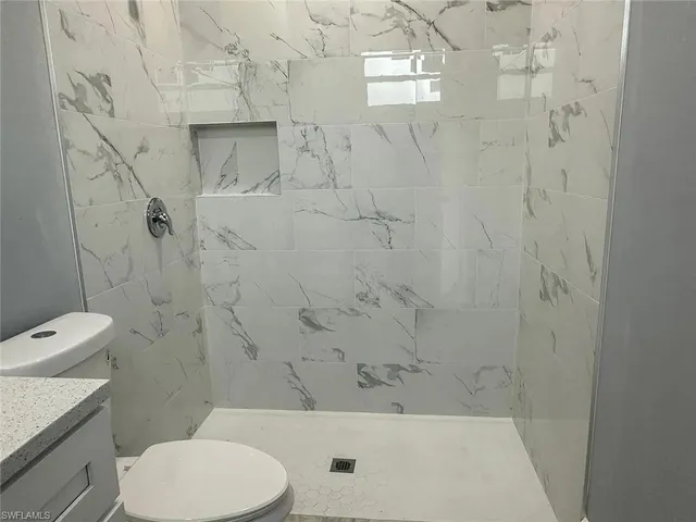a bathroom with a toilet and a shower