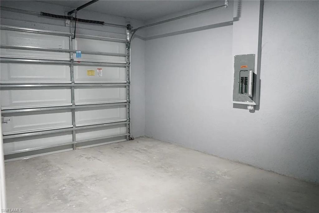 742 Eisenhower Boulevard Lehigh Acres, FL 33974 - Photo 10 of 11 a view of an empty room with shelves