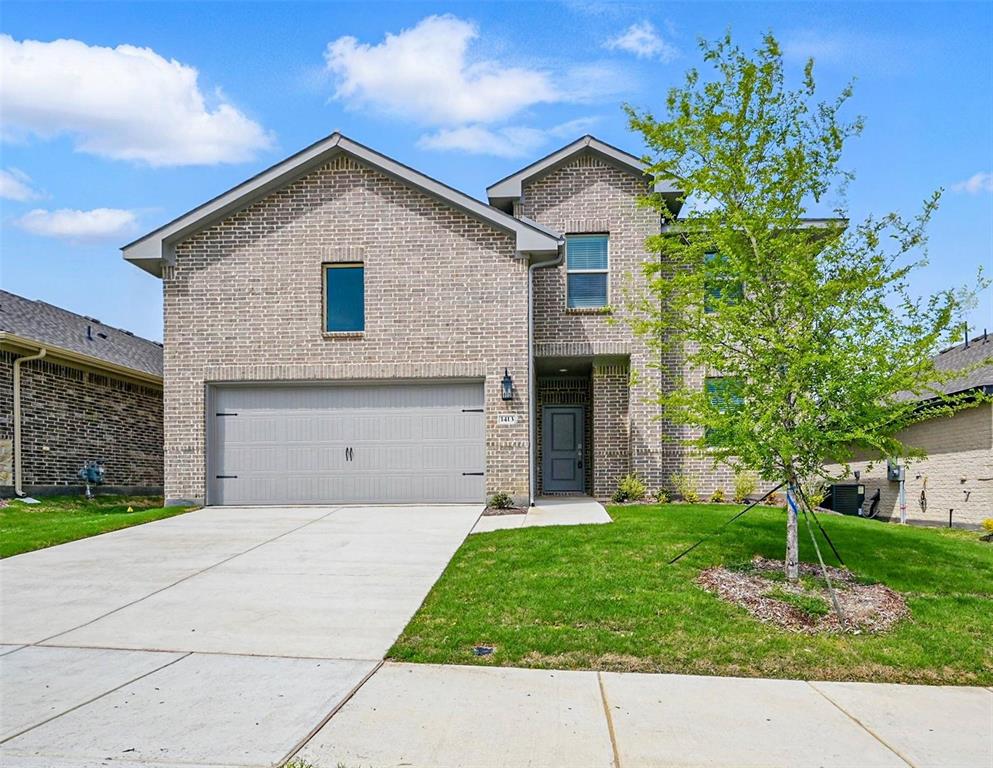 1413 Richardson Street Howe, TX 75459 - Photo 1 of 30 Two-story brick exterior featuring a two-car garage with a gray door, an inviting entryway with a dark gray door, a concrete driveway, and a manicured front lawn with a young tree