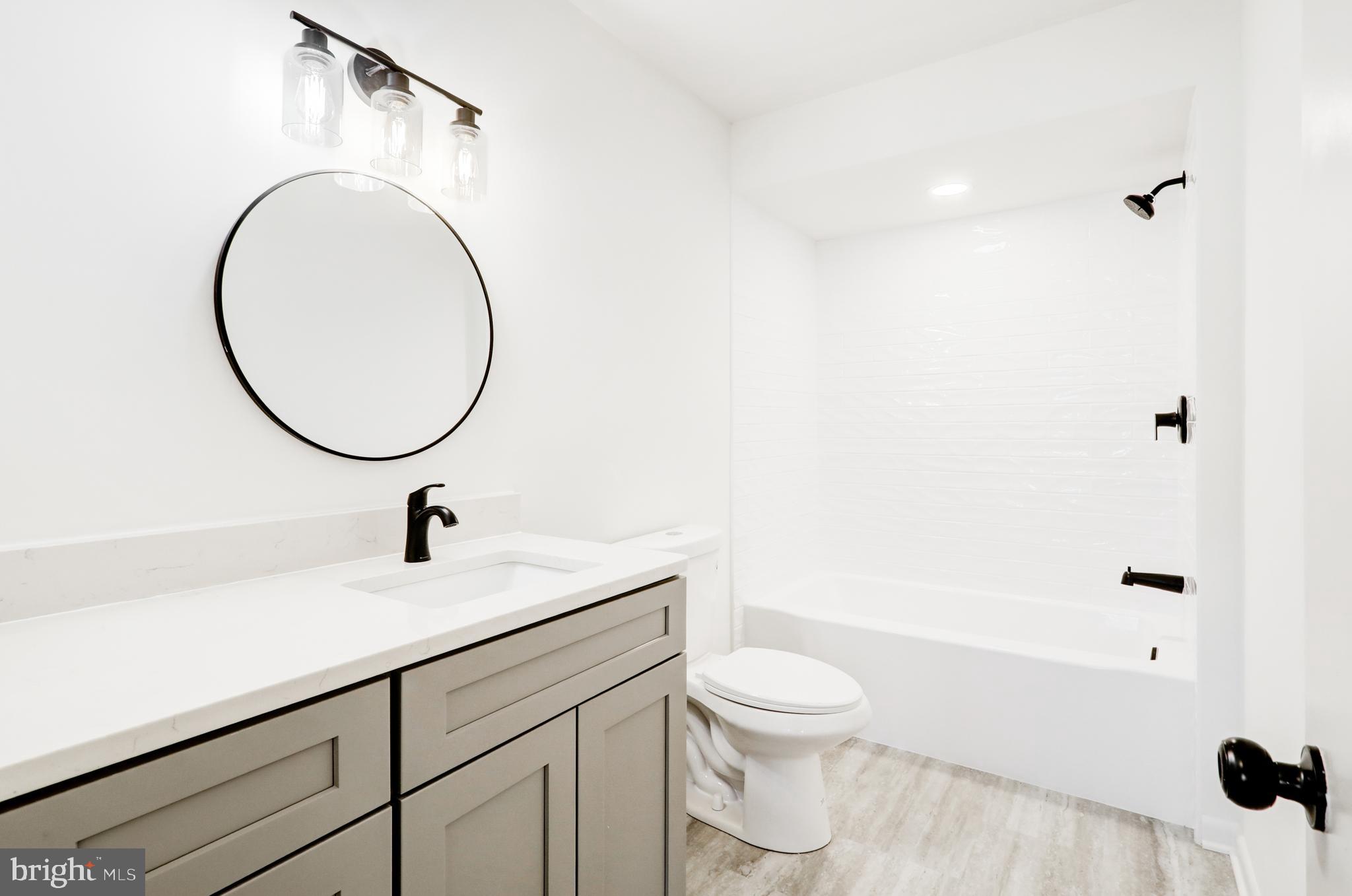 163 Thomas Place Reading, PA 19608 - Photo 23 of 36 a bathroom with a sink a toilet and a mirror