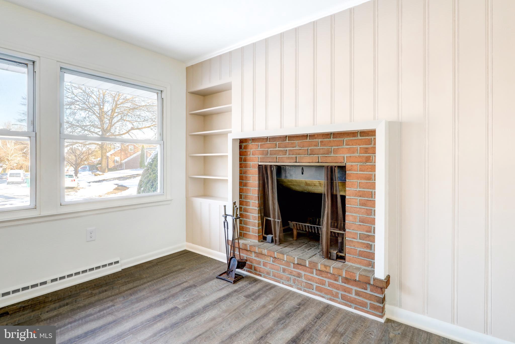 163 Thomas Place Reading, PA 19608 - Photo 3 of 36 a living room with a fireplace and a window