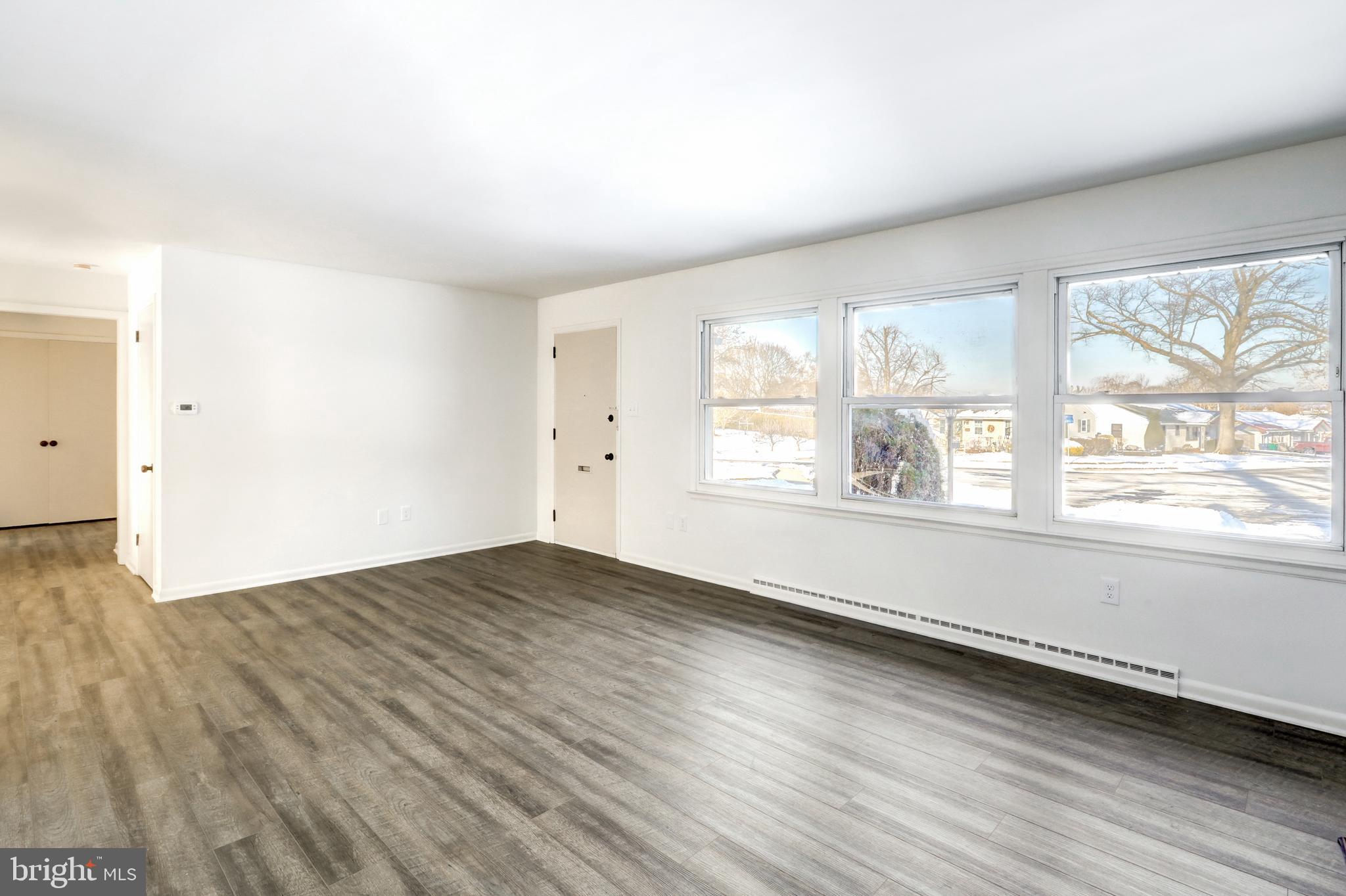 163 Thomas Place Reading, PA 19608 - Photo 4 of 36 an empty room with wooden floor and windows