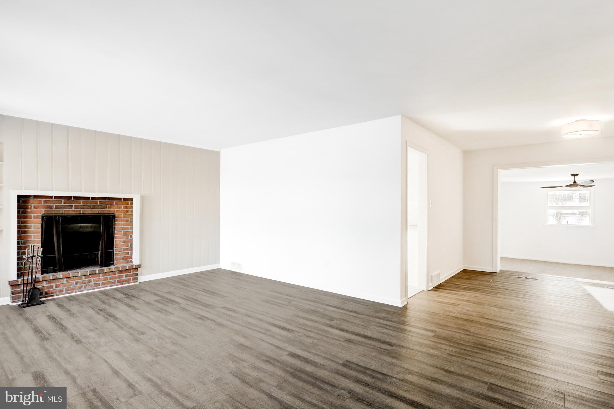 163 Thomas Place Reading, PA 19608 - Photo 5 of 36 a view of an empty room with wooden floor and a fireplace