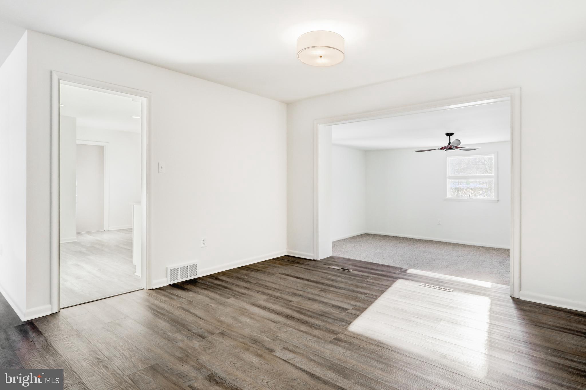 163 Thomas Place Reading, PA 19608 - Photo 6 of 36 an empty room with wooden floor and windows