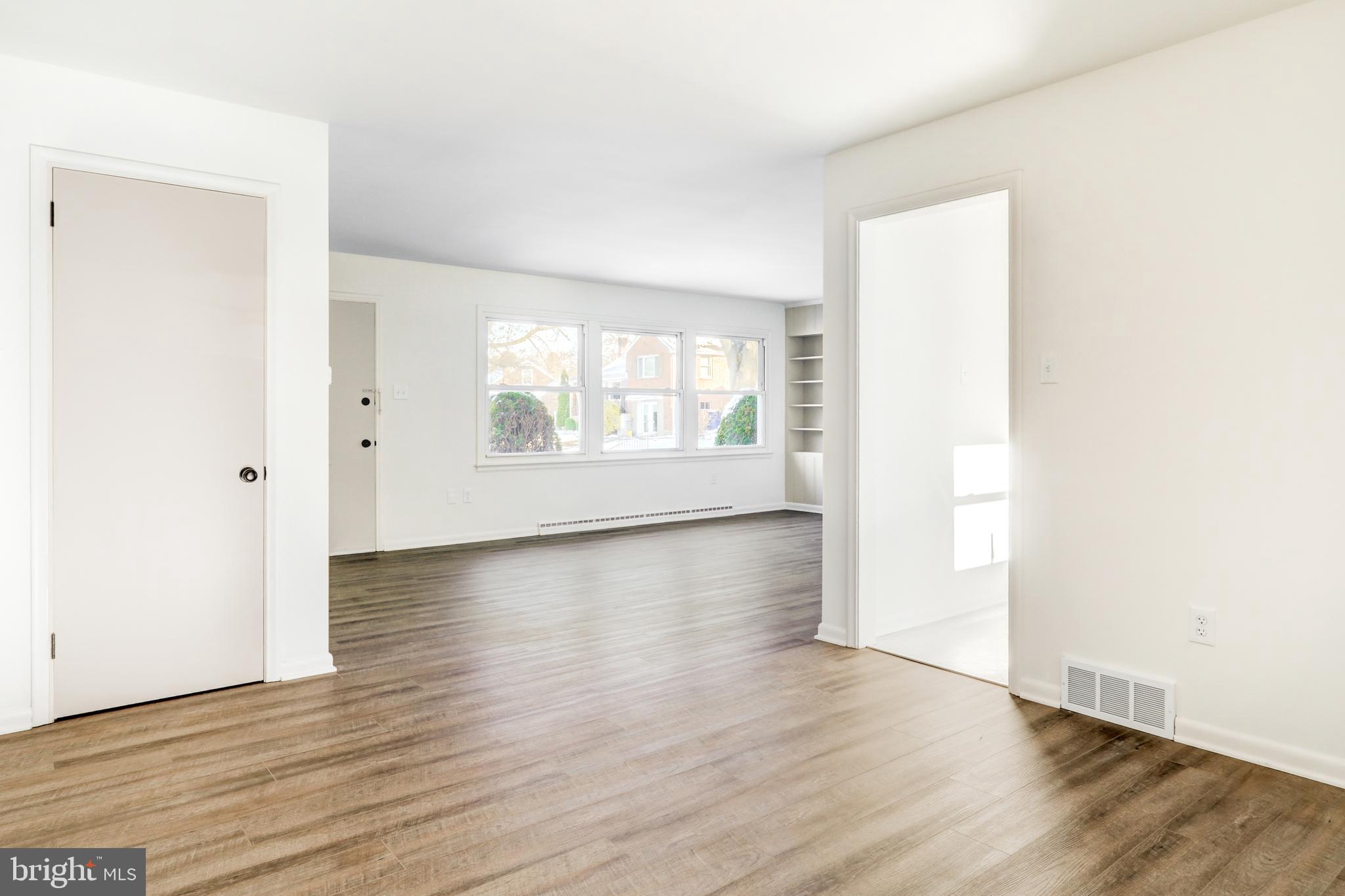 163 Thomas Place Reading, PA 19608 - Photo 7 of 36 an empty room with wooden floor and windows