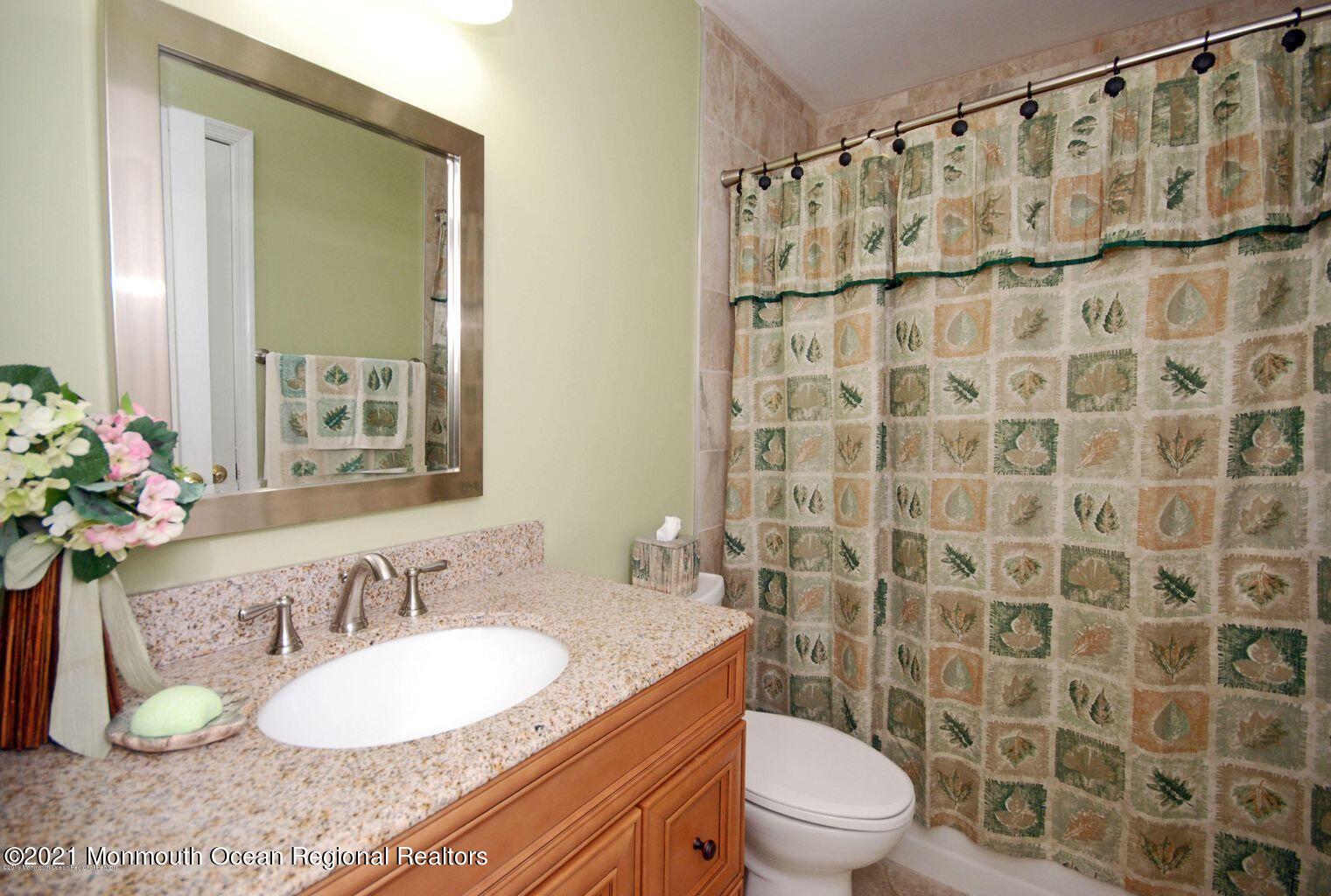 32 Waverly Lane Jackson, NJ 08527 - Photo 13 of 19 a bathroom with a granite countertop sink a toilet and a mirror