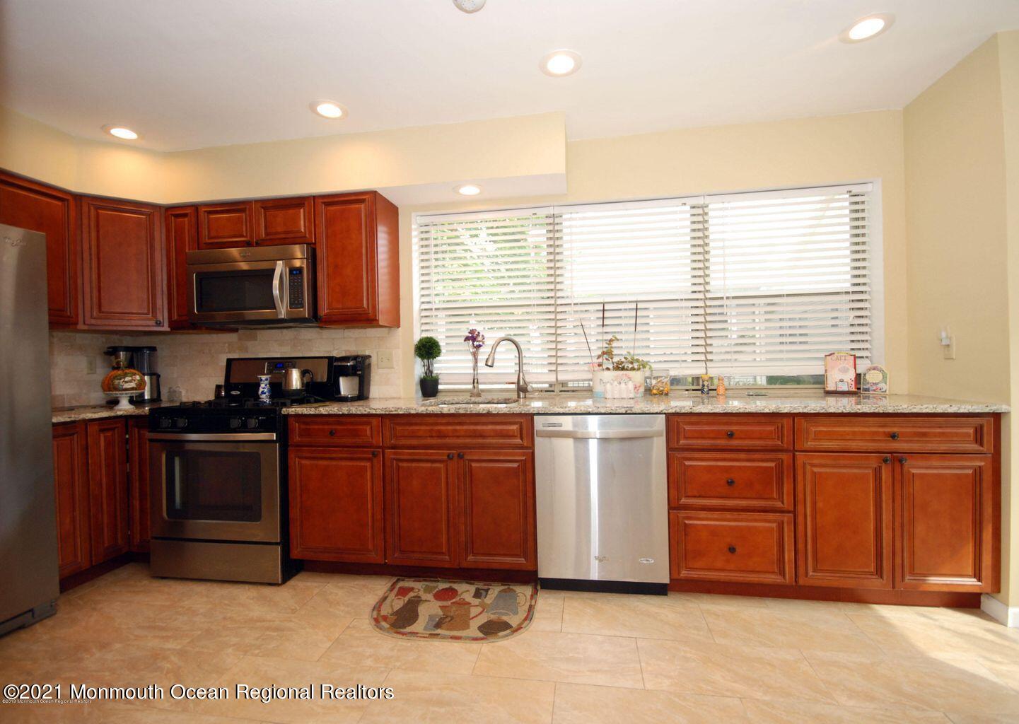 32 Waverly Lane Jackson, NJ 08527 - Photo 6 of 19 a kitchen with stainless steel appliances granite countertop a stove a sink and a microwave
