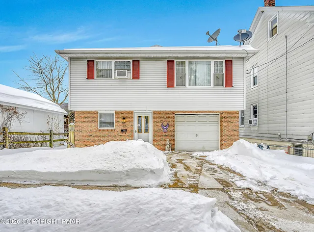 a view of a house with snow on the background