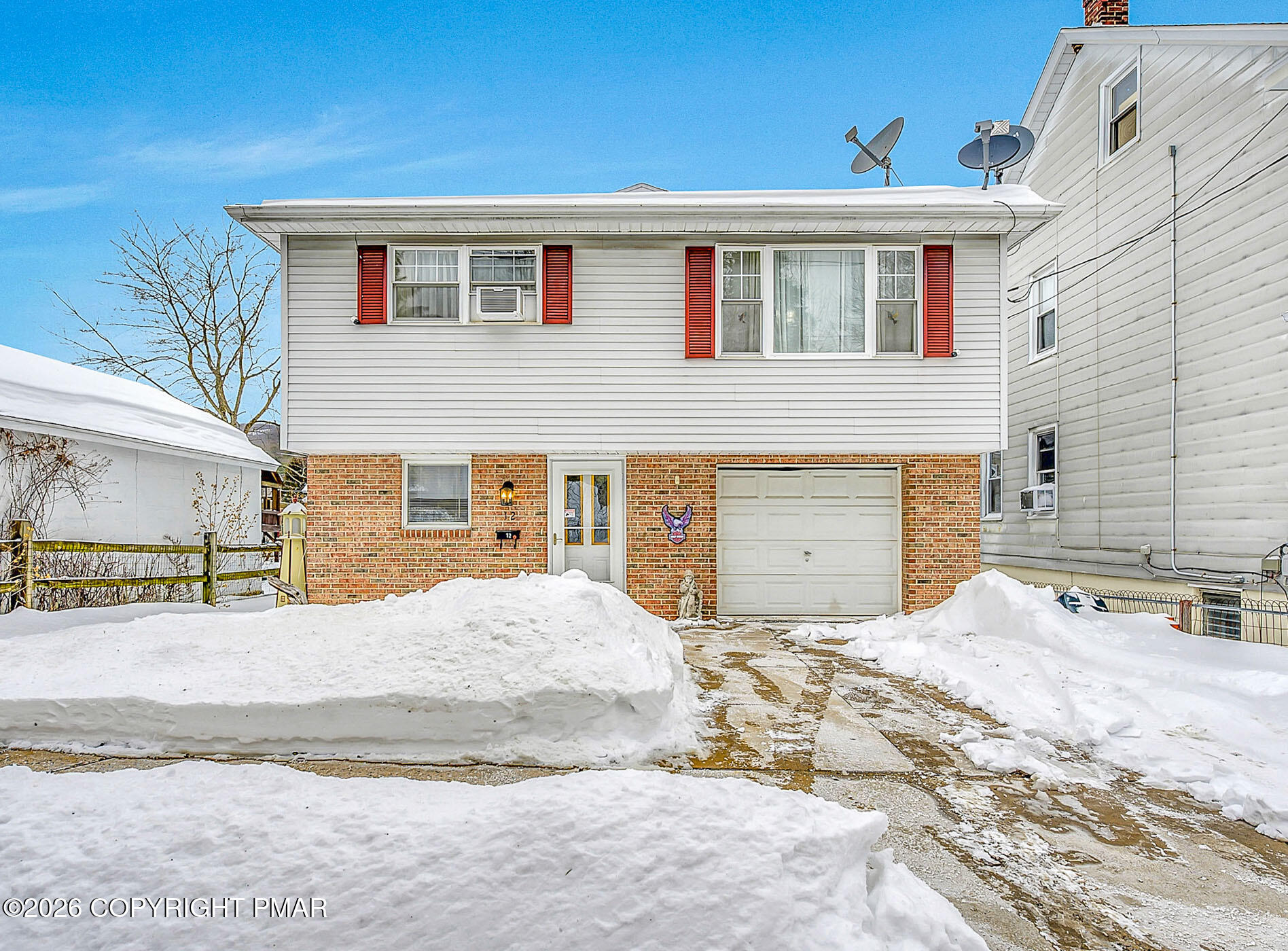 a view of a house with snow on the background
