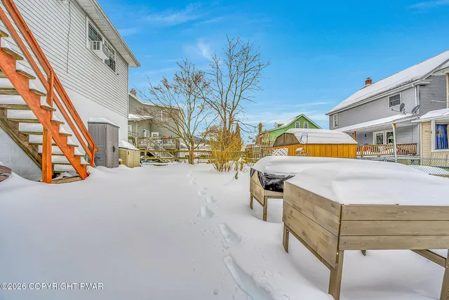a kitchen with stainless steel appliances a stove a refrigerator a sink and a wooden cabinets