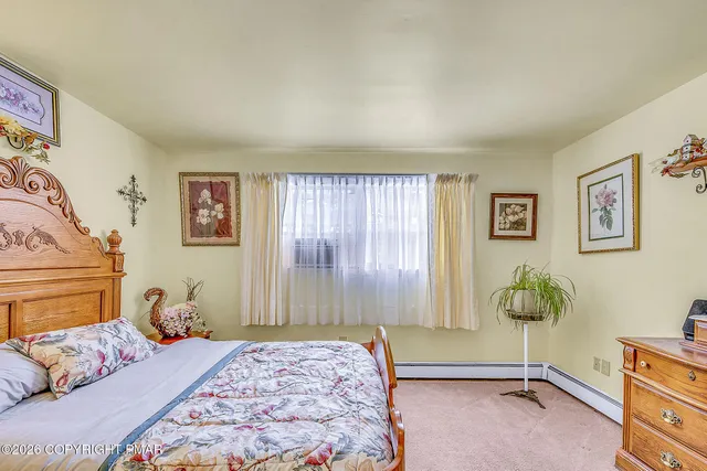 a bedroom with a bed and a dresser in it