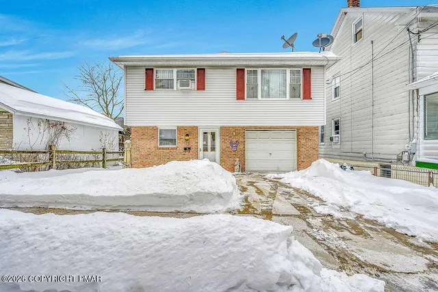 a view of a patio with table and chairs and couches with wooden fence
