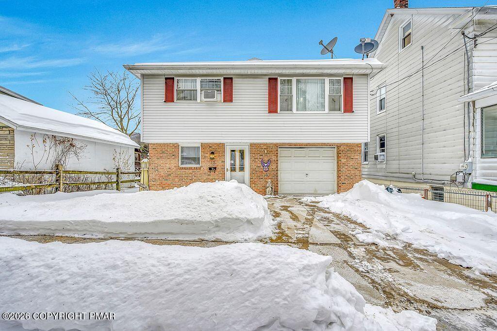 12 Coal Street Nesquehoning, PA 18240 - Photo 34 of 37 a front view of a house with a yard and garage