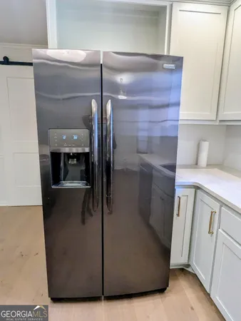 a view of an empty room with a fireplace and a window