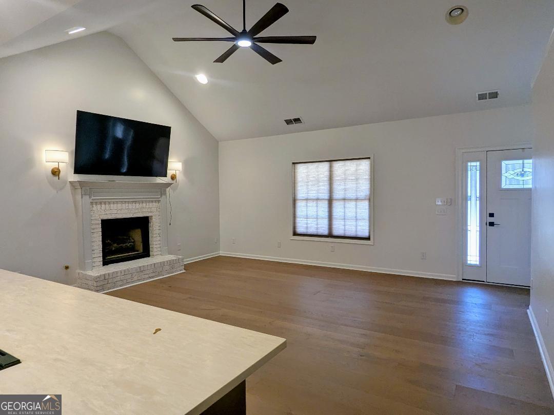 161 Hancock Road Williamson, GA 30292 - Photo 12 of 44 a view of an empty room with a fireplace and a window
