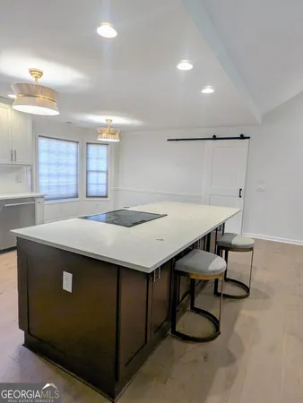 a view of a refrigerator in kitchen and wooden floor